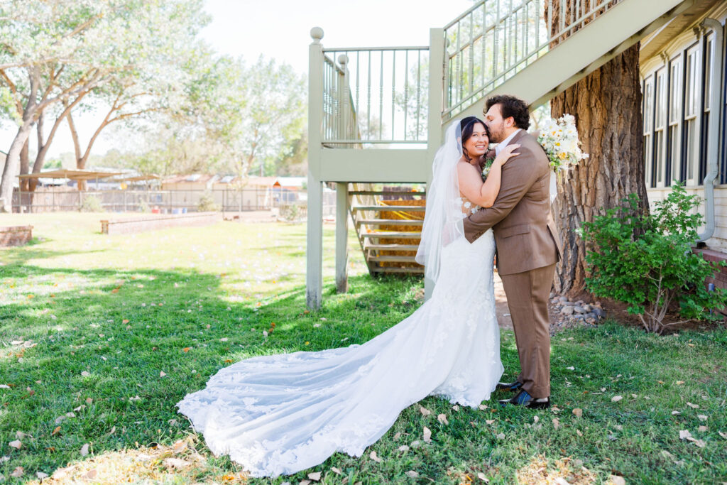 bride and groom in front of exterior staircase