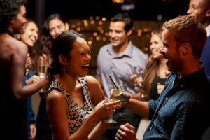 group of friends, laughing, drinks in hand