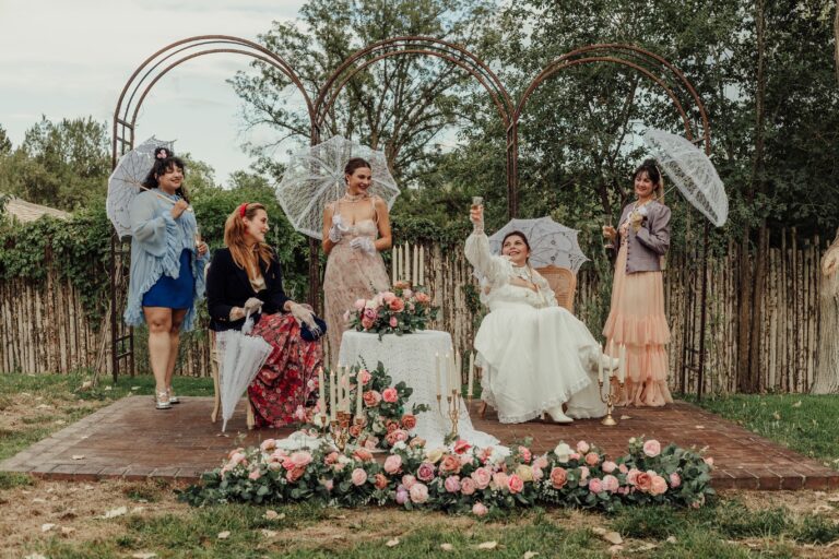 Women in Victorian dress in the garden of Heritage House