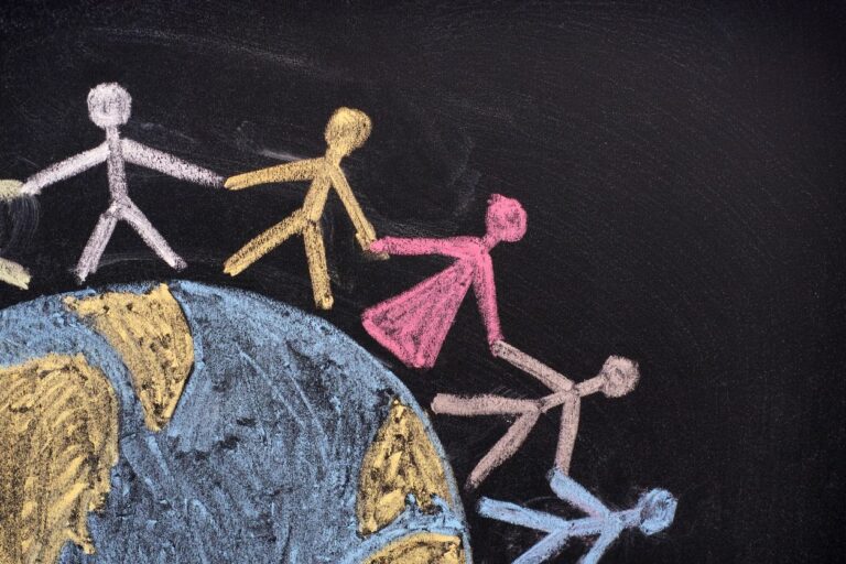 chalk people holding hands around a globe