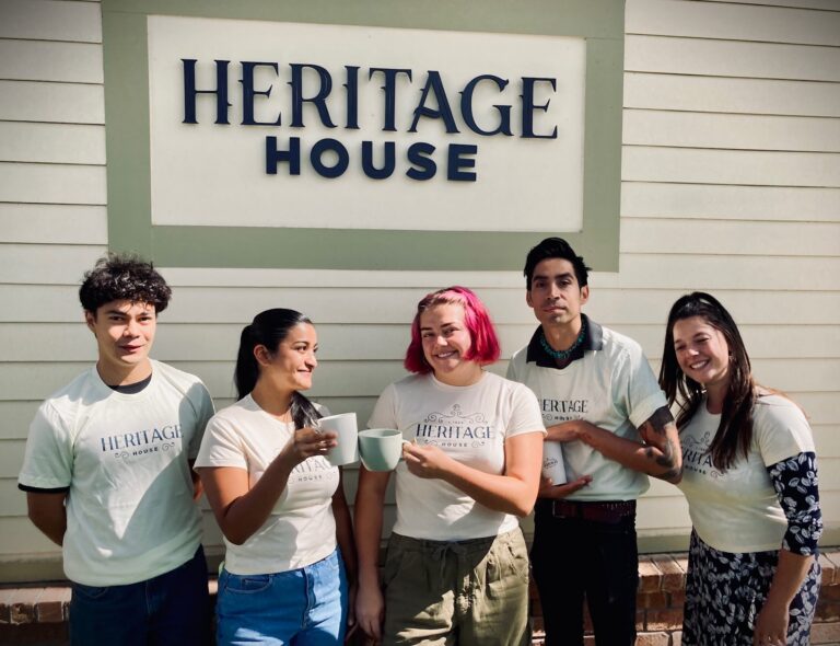 some of our employees, standing together in Heritage House shirts and holding coffee cups